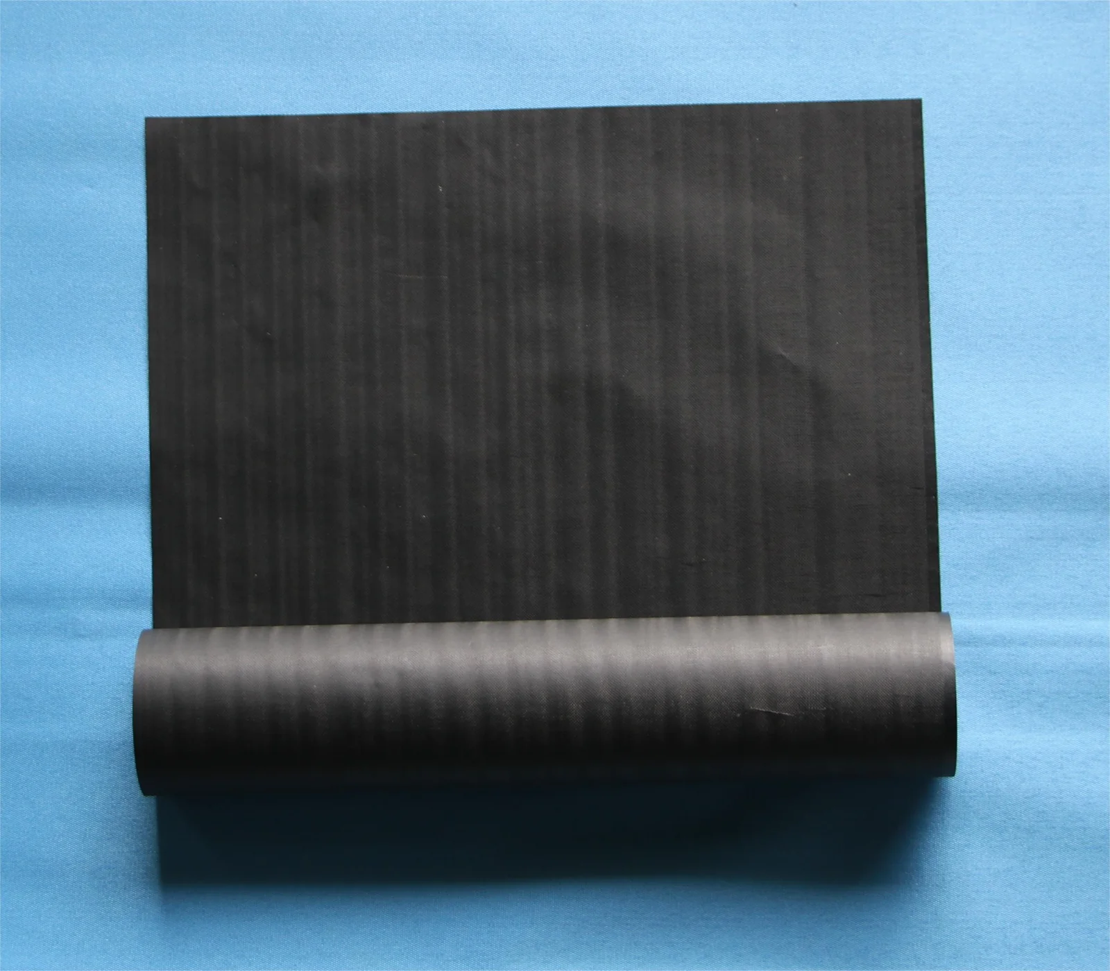 Graphene-coated black conductive cloth roll with release liner, ready for die-cutting